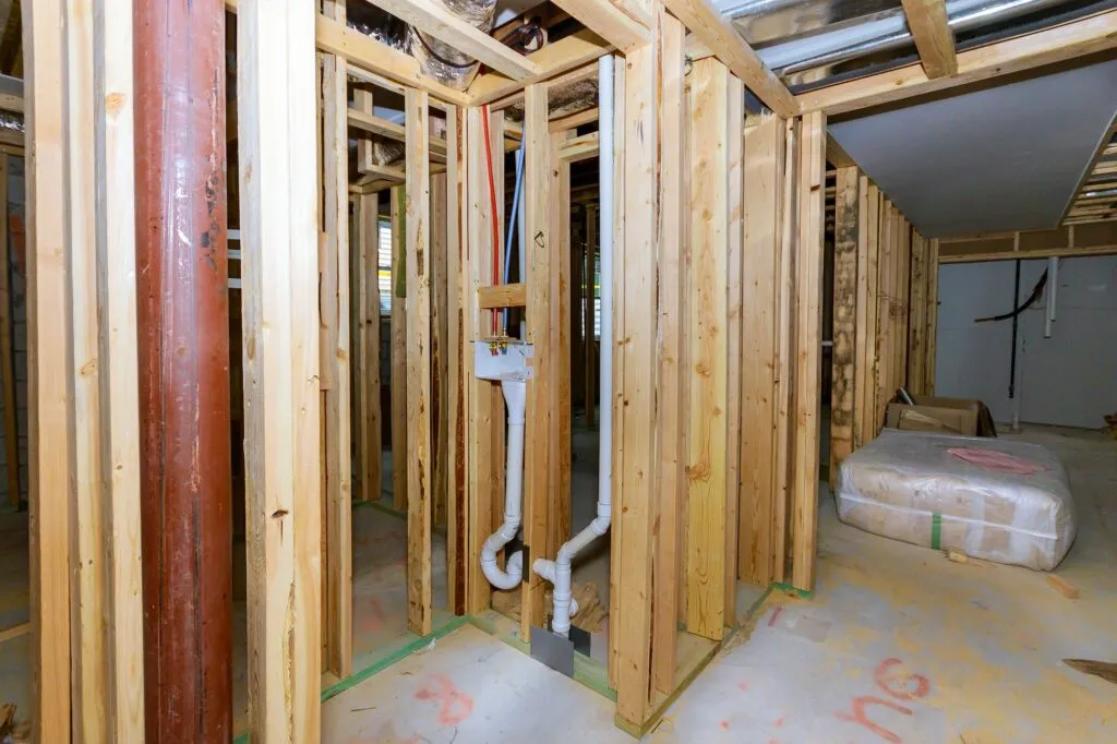 Home construction with plumbing for the laundry room unfinished basement remodeling project